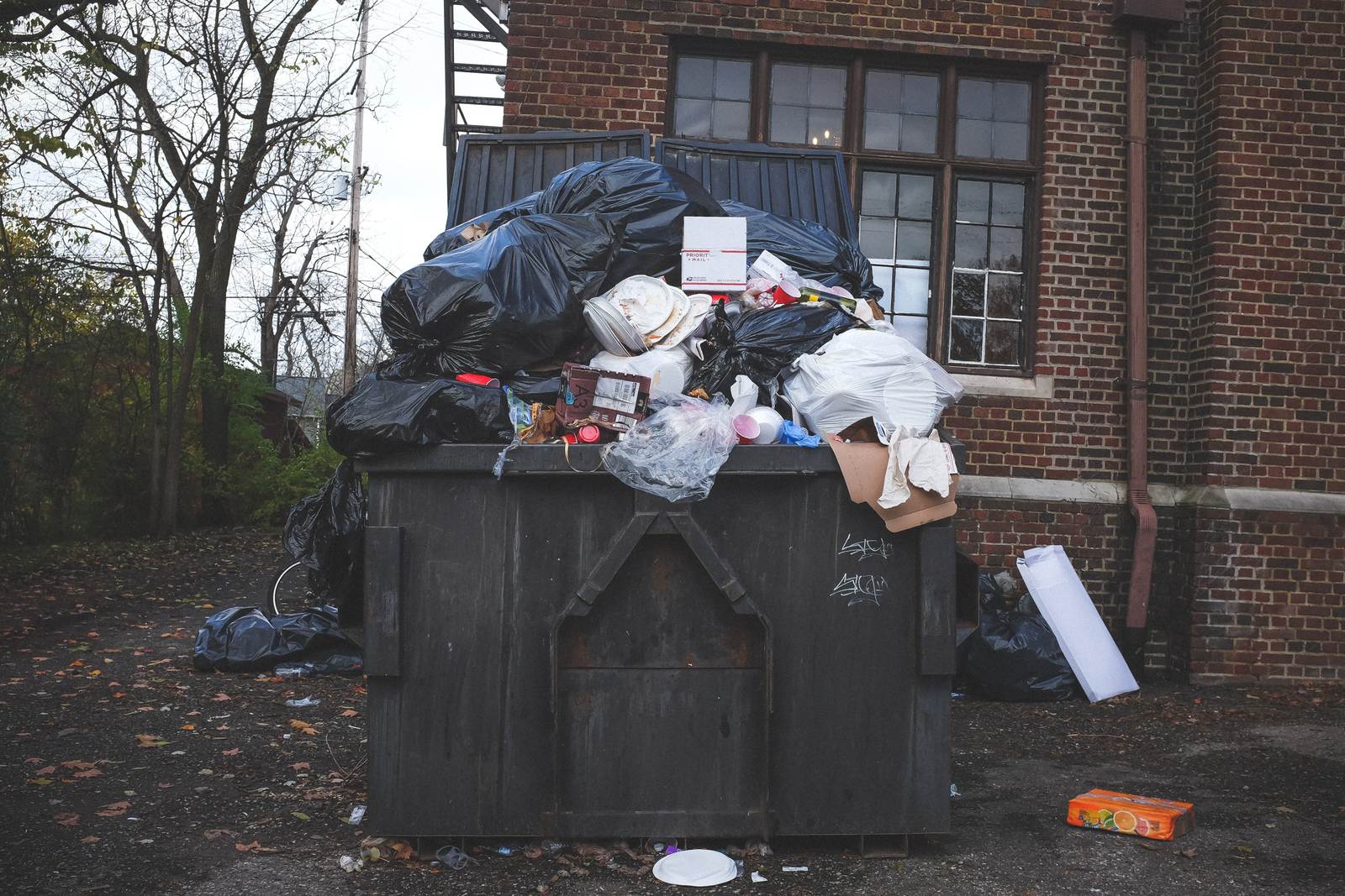 Photo of an overflowing skip filled with potentially recyclable materials